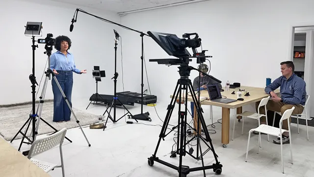 USU BTS BTS shot of an educational course befing developed in a white video studio with an African American/Korean woman reading from a teleprompter.