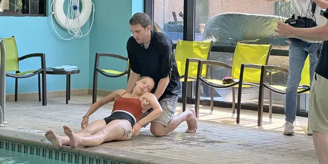 Medical emergency eLearning video of a man pulling a drowning woman from the pool.