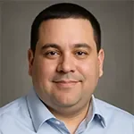 Sony Product Manager Headshot of an eLearning professional in a blue button down shirt.